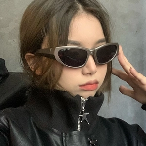 Y2K style futuristic silver wrap sunglasses with black lenses worn by a model