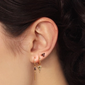 Three-piece gold earring set with black triangle pendant and red stone cluster studs