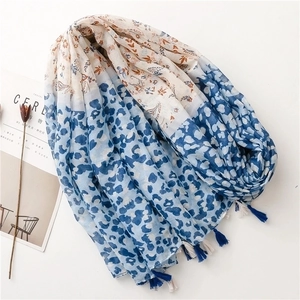 Bohemian blue leopard and floral print scarf with tassels on white background