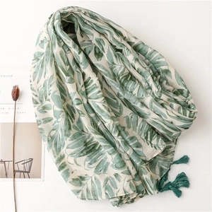 Light green cotton linen beach shawl with tropical leaf prints and fringe tassels