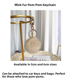 Detail of 5cm and 6cm mink fur ball charms with gold metal rings for luxury bags