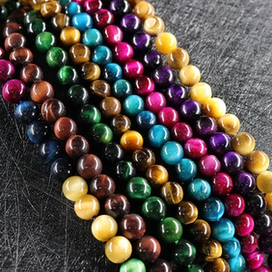 Detailed macro shot of multicolored tiger eye stone round beads showing cat eye effect