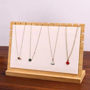 Bamboo necklace display stand with white padded slots for multiple jewelry organization