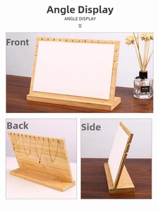 Bamboo jewelry display stand with multiple slots for organizing necklaces and pendants