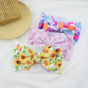 Detailed view of three baby headbands with watercolor, unicorn, and sunflower prints