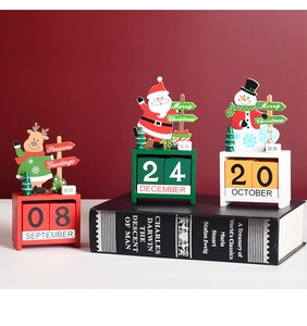 Detail of wooden Christmas countdown calendars with elk, Santa Claus, and snowman designs