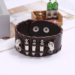 Detail of punk leather bracelet featuring silver skull and bullet rivets with snap fastener