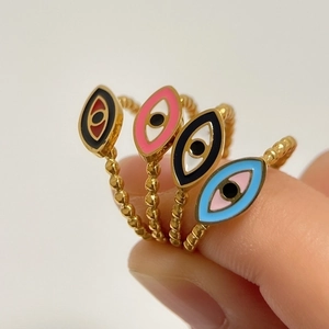 Set of four colorful enamel Evil Eye open rings with golden beaded bands on fingers
