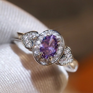 Vintage ring with oval purple zircon center stone and heart-shaped side accents
