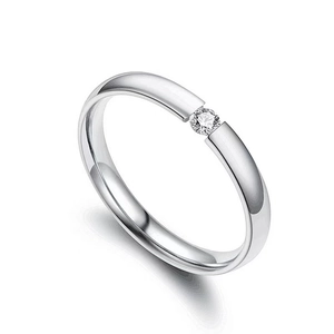 Minimalist silver couple ring with tension set zircon stone on a white studio background