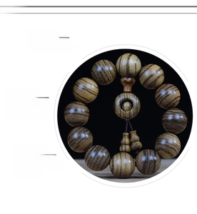 Close-up of polished 108 wood prayer beads with natural textures and ruyi knot charm