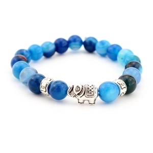 Detail of blue agate bead bracelet featuring a silver elephant charm and floral spacers