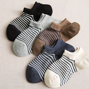 Five pairs of men's striped low-cut cotton ankle socks in various colors on fabric