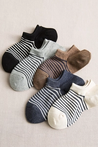 Detail view of five pairs of striped low cut socks in black, grey, brown, blue and beige