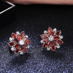 Detail view of sunflower earrings with red and white marquise-cut cubic zirconia
