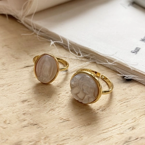 Detailed close-up of S925 hallmark on gold plated vintage shell cameo open rings