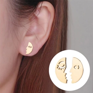 Minimalist asymmetric abstract face earrings in polished gold-tone hollow design