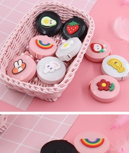 Flachbild von bunten Mini-Maßbändern mit Cartoon-Motiven in einem rosa Korb dekor