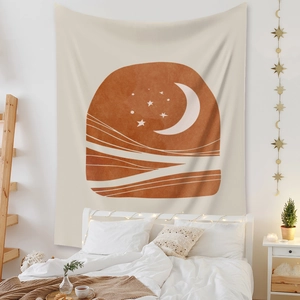 Detail of bohemian sun and moon tapestry hanging above a bed in a cozy bedroom