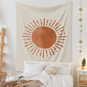 Detail of bohemian sun tapestry hanging above bed with warm decorative LED string lights