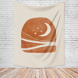 Detail of bohemian sun and moon tapestry hanging on a textured white brick wall