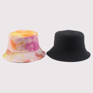 Detail showing tie-dye pink orange pattern and classic black cotton bucket hats side by side