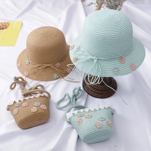 Detail of children's straw hats and matching bags with daisy flowers and lace trim