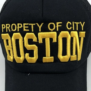 Close-up of golden 3D embroidery showing Property of City Boston on black mesh cap