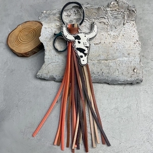 Western style cow head keychain with black white spots and colorful leather tassels
