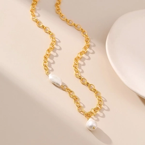 French irregular pearl necklace in 18K gold plated brass on elegant ceramic display