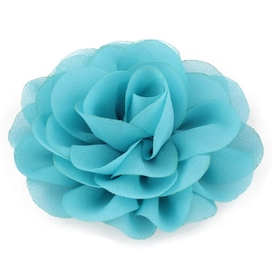 Macro detail of multi-layered lake blue chiffon flower hair clip with petal texture