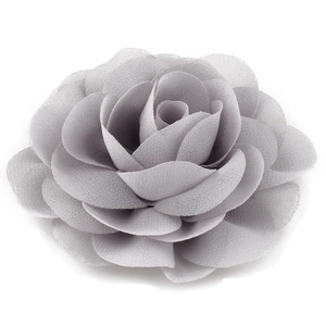 Detailed close-up of a multi-layer grey chiffon flower hairpin with soft fabric texture