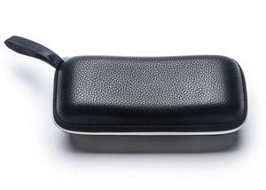 Detail shot of black litchi pattern leather sunglass case with a zipper and hand strap