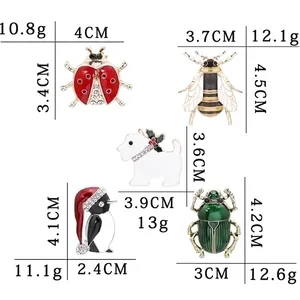 Size chart for colorful enamel animal brooches featuring bee, ladybug, and penguin designs