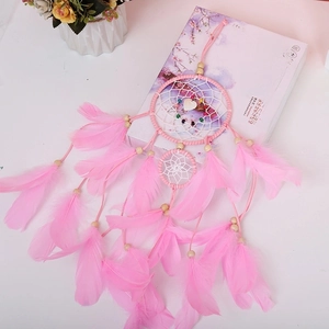 Close-up of pink dreamcatcher with soft feathers and beads on a clean white background