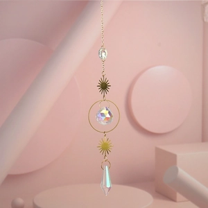 Detailed close-up of golden sun crystal prism hanging ornament with iridescent droplets