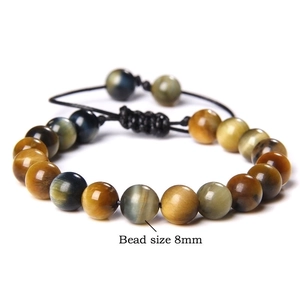 Close-up of 8mm tiger eye beads with natural chatoyancy on adjustable woven cord