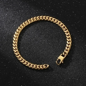Polished golden stainless steel Cuban link bracelet with lobster clasp on black background