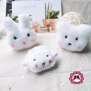 Close-up of plush cartoon rabbit, cat, and lamb earphone cases with soft pink blush detail