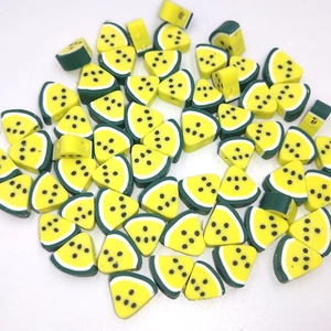 Detailed macro shot of yellow watermelon polymer clay beads for DIY jewelry making