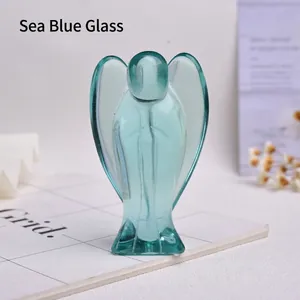 Detailed close-up of a translucent sea blue glass angel figurine with polished edges