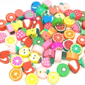 Detailed close-up of mixed colorful fruit polymer clay beads for DIY craft bracelets