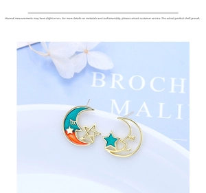 Detailed close-up of crescent moon and star stud earrings with colorful enamel inlay