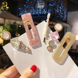 Detail of Korean acetate and pearl hair clips set with pink resin and gold glitter