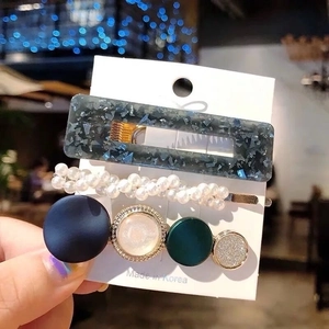 Set of 3 hair clips including navy glitter and pearl designs on a Korean card