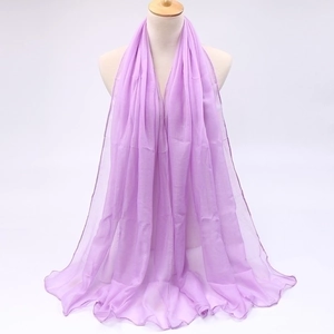 Detail view of light purple voile scarf with sheer texture and fine hemmed edges