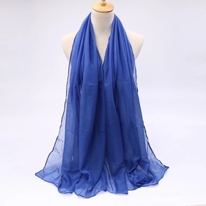 Detail of lightweight blue voile sun protection scarf with a soft semi-sheer texture
