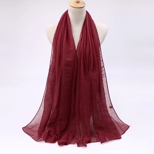 Detailed texture of wine red semi-transparent voile fabric sun protection scarf