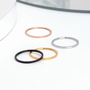 Set of four minimalist stainless steel rings in rose gold, gold, silver, and black finish