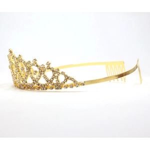 Detailed close-up of a sparkling gold crown tiara with rhinestones and hair comb teeth